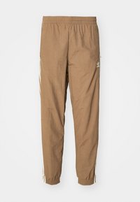 Bruna Adidas träningbyxor med elastisk midja och mudd, med vita ränder längs sidorna och en liten Adidas-logotyp på höger lår.