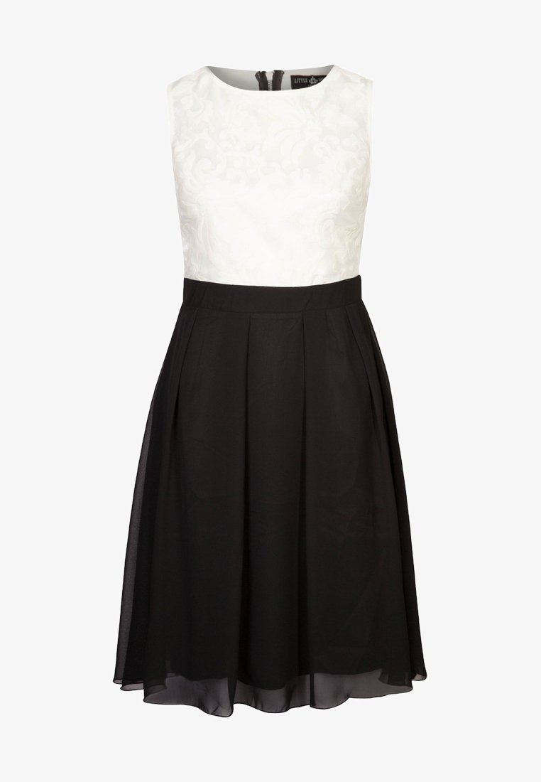 Robe sans manches avec un corsage texturé blanc et une jupe plissée noire. Dispose d'un col rond et d'une fermeture éclair discrète au dos.