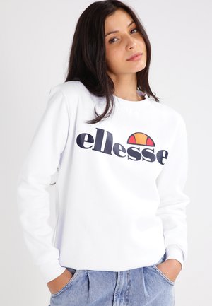 Sudadera blanca de manga larga, con un destacado logo negro "ellesse" y un gráfico de medio sol colorido. Corte casual, textura suave.