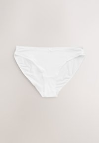 Culotte bikini en coton blanc pour femme avec un petit nœud décoratif au centre de la ceinture avant sur fond neutre.