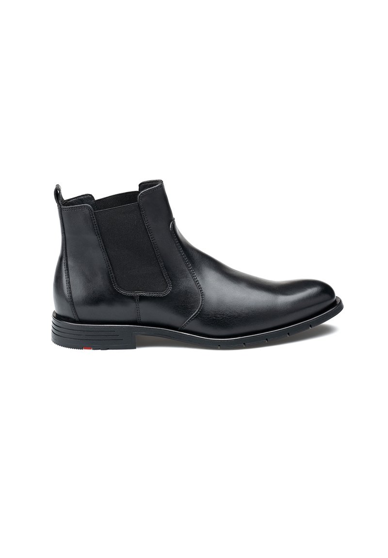 Stivale Chelsea in pelle nera con pannelli laterali elasticizzati, punta tonda e suola testurizzata. Presenta dettagli di accento sottili sul tallone.