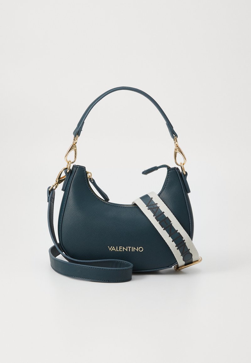 Teal leather handbag with a curved shape, gold hardware, and a removable striped strap featuring "VALENTINO" logo. Textured finish.