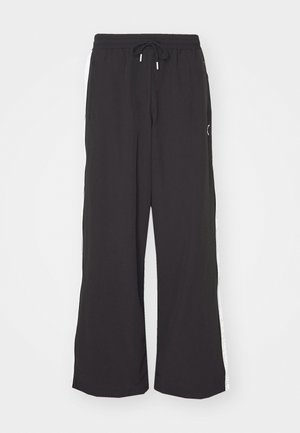 Black wide-leg sweatpants with an elastic waistband and drawstring. Features white side stripes and two side pockets. Smooth texture.