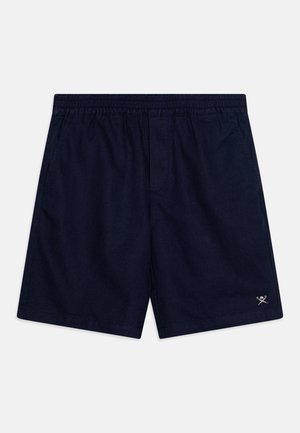 Calções azul-marinho com cintura elástica, apresentando bolsos laterais e um pequeno logótipo na bainha inferior. Textura do tecido suave.