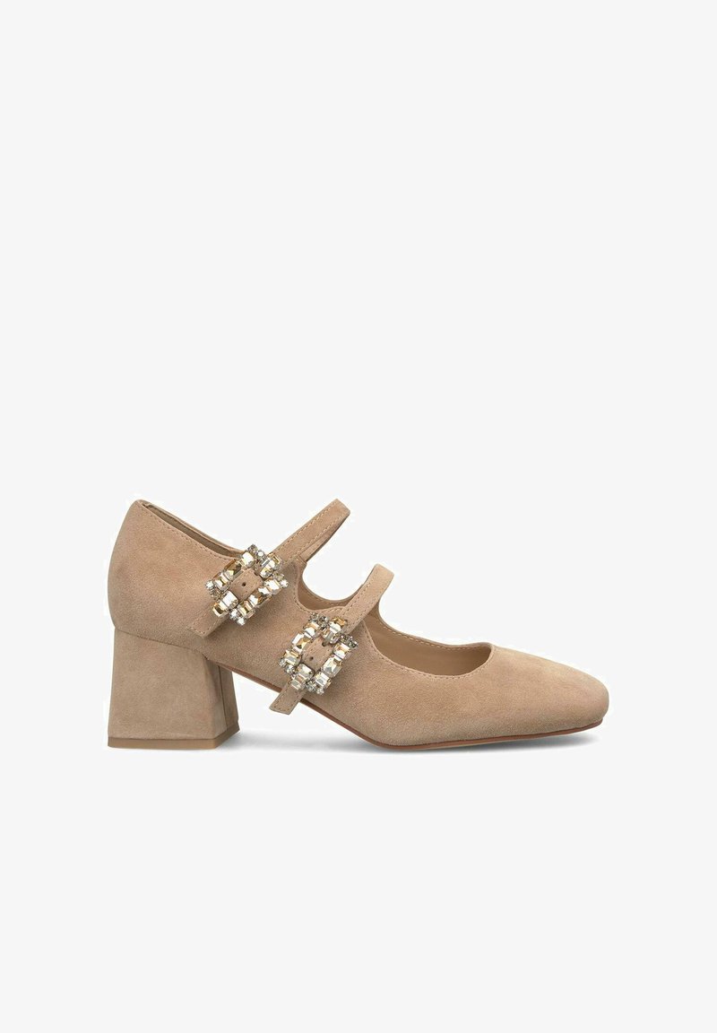 Beige suede Mary Jane shoe with a squared toe, block heel, and two adjustable straps adorned with crystal-like embellishments.
