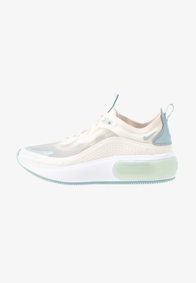 Light beige and mint green Nike sneaker with translucent mesh upper, thick white sole, and pull tabs on tongue and heel.