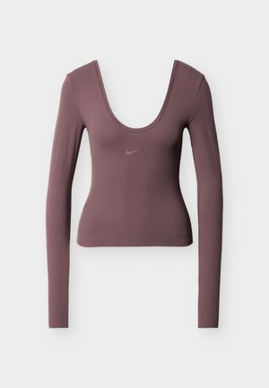 Dugi rukav u tamnom jorgandžinom tkaninom, s dubokim okruglim izrezom i suptilnim Nike logotipom na prsima. Glatka tekstura, kroj koji prati liniju tijela.