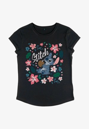 Sort kortærmet t-shirt med et farverigt grafik af Stitch omgivet af pink og teal blomster og grønne blade, med "Stitch" tekst.
