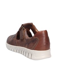 Brown leather shoe with open sides, featuring a hook-and-loop strap. White flexible sole with a textured pattern, enhancing support and grip.