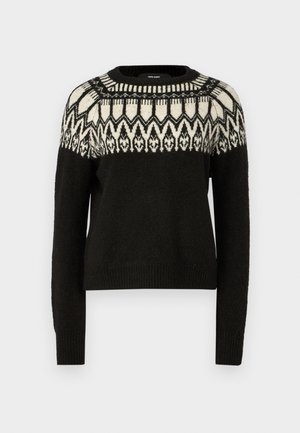 Suéter negro con escote redondo y mangas largas. Presenta un diseño de yugo en blanco y negro con patrones. Textura suave y dobladillo acanalado.