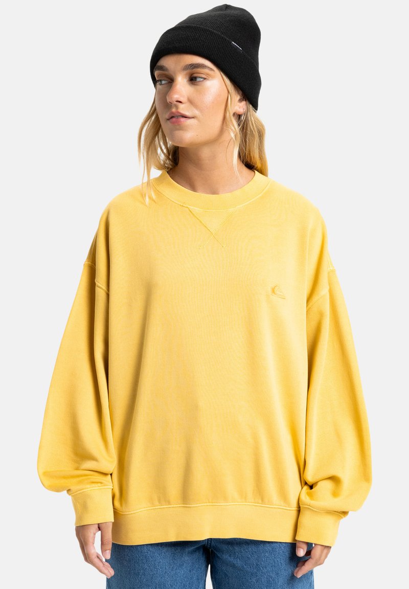 Geel oversized sweatshirt met een ronde halslijn en verlaagde schouders. Zacht katoenmateriaal, met een klein logo op de borst.