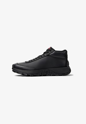 Black high-top sneaker made of textured leather with a rugged rubber sole, featuring laces and a logo accent near the ankle.