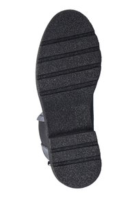 Zwarte rubberen zool met textuur voor grip en horizontale groeven. Afgeronde teenvorm en lichte zijverhoging. Nummer 37 zichtbaar.