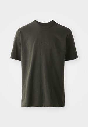 T-shirt vert foncé en tissu doux, avec un col rond et des manches courtes. Logo "nike" brodé dans un vert légèrement plus foncé.