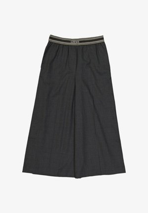Pantalon à jambes larges gris foncé avec taille élastique portant la marque « LOEWE » en rayures blanches et beiges.