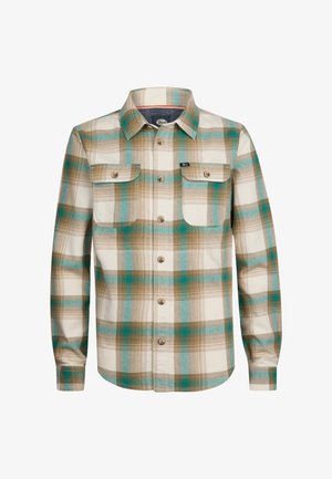 Kariertes Hemd in Grün-, Blau- und Brauntönen mit Button-Down-Kragen und zwei Vordertaschen, kombiniert mit braunen Cordhosen und weißen Sneakern.