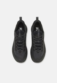 Black athletic shoes featuring mesh and synthetic material, textured surfaces, reflective laces, and a pull tab on the heel.