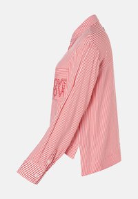 Red and white striped shirt with a rounded hem, long sleeves, button cuffs, and a front pocket featuring a text detail.