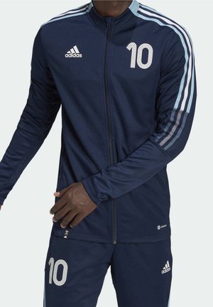 Marineblaue Adidas-Sportjacke und -Hose mit hellblauen Streifen an den Ärmeln und der Nummer 10 auf Brust und Oberschenkel gedruckt.