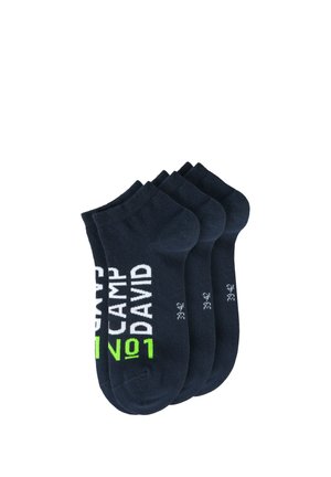 Four pairs of black ankle socks stacked, featuring white and green "CAMP DAVID No1" text and size 39-42 on each sock.