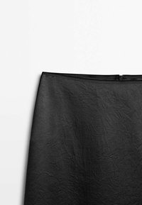 Black pencil skirt featuring a textured finish, a fitted shape, and a side zipper closure. Material appears lightweight and crinkled.