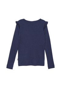 Tunika merenka pitkät hihat, ribattua tekstiiliä, pyöreä pääntie ja röyhelökoristeet olkapäillä. Yksinkertainen, slim fit -muotoilu ilman näkyvää brändäystä.