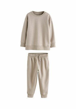 Light beige two-piece sweat outfit featuring a crewneck sweatshirt with ribbed cuffs and matching drawstring pants with elastic waistband.