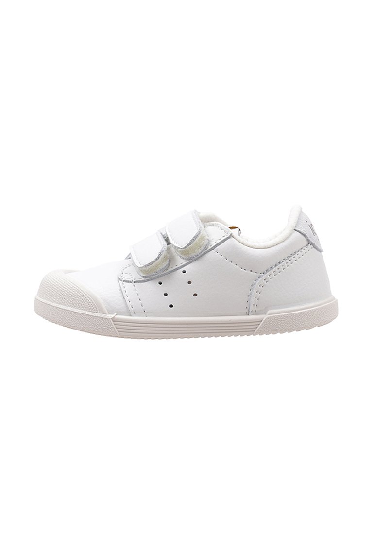 Zapatilla blanca de piel con dos correas de velcro, punta redondeada, detalles perforados en los laterales y una suela de goma texturizada.