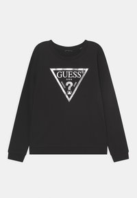 Sudadera negra de algodón con mangas largas, que presenta un logo metálico plateado en un diseño triangular en el frente.