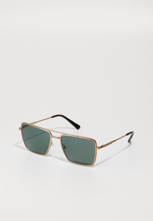 Rectangular sunglasses with dark green lenses, gold metal frame, and tortoiseshell temples. Clear nose pads for comfort.