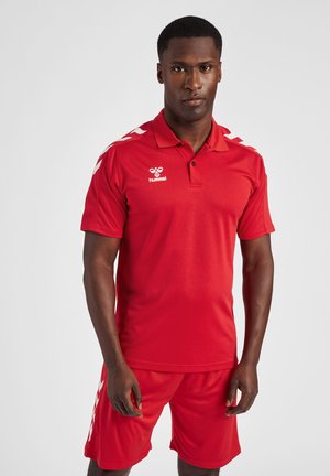 Red athletic polo and shorts set made of moisture-wicking fabric. Features a collar and white branding, with contrasting shoulder stripes.