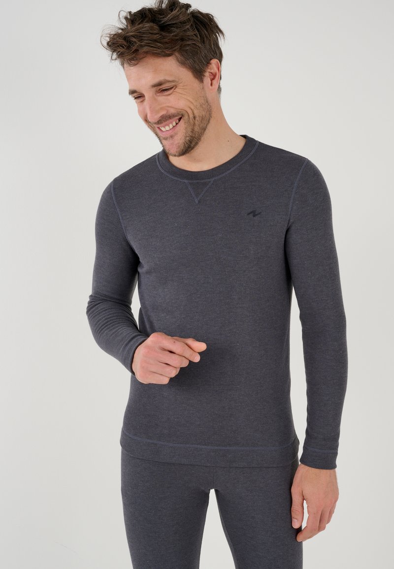 Maglietta a maniche lunghe grigia scura con scollo rotondo, texture a coste e dettagli di cucitura sottili, abbinata a pantaloni coordinati.