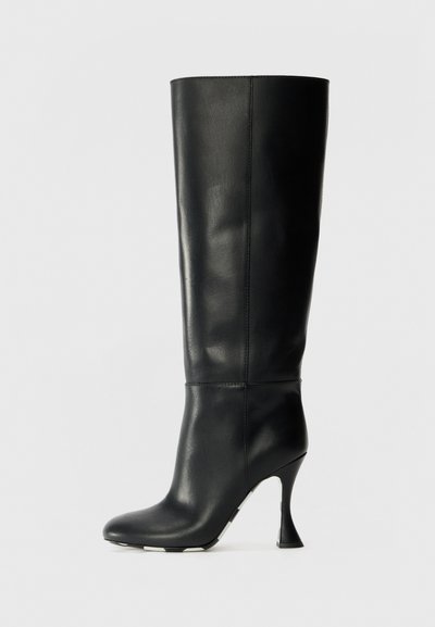 Black leather knee-high boot with a fitted shaft and pointed toe. Features a distinctive curved heel and smooth textured surface.