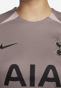 Camiseta de fútbol de color púrpura claro con un logo de Nike negro, gran texto "AIA" y un emblema negro detallado en el lado izquierdo del pecho.
