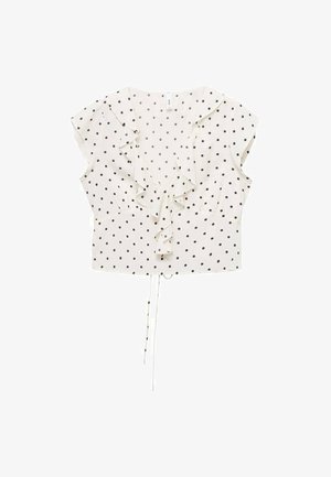 Blusa bianca con pois neri, maniche corte a sbuffo, dettaglio arricciato sul davanti e orlo con cordino per una vestibilità regolabile.