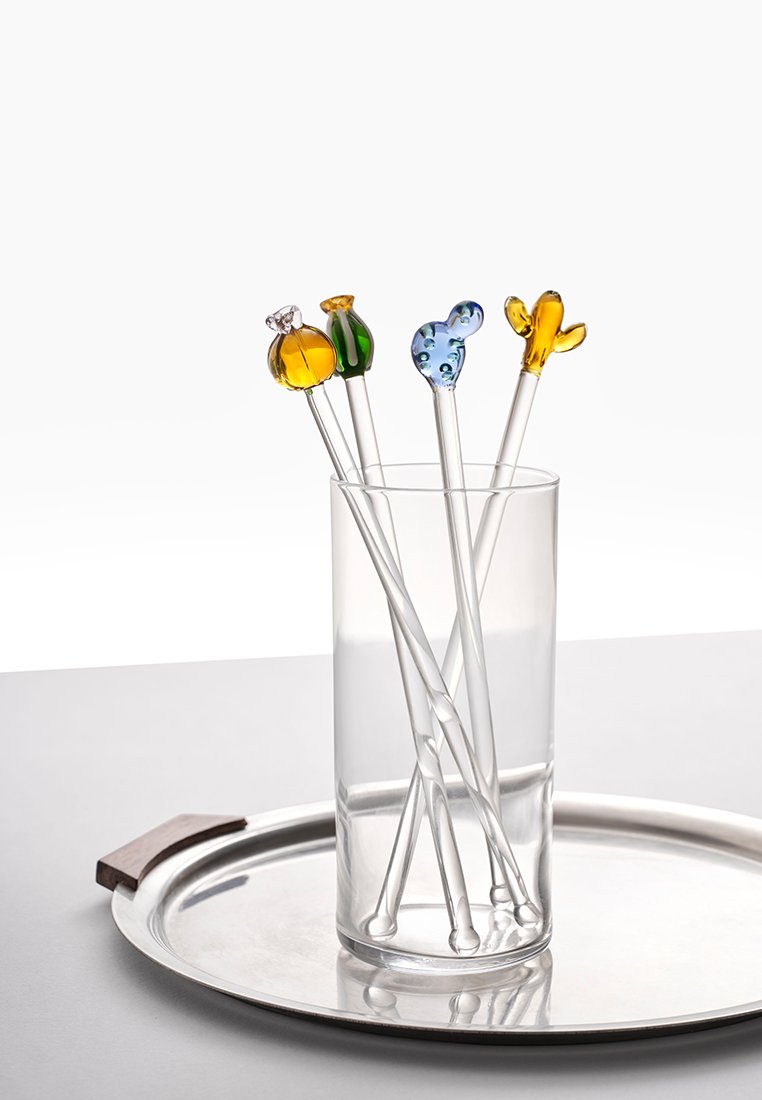 Zestaw sześciu szklanych mieszadełek w przezroczystym uchwycie, z kolorowymi dekoracyjnymi końcówkami: bursztynową, zieloną, niebieską i żółtą. Gładki, cylindryczny kształt.