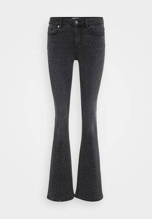 Black flared jeans made of denim, featuring metallic studded embellishments throughout. Five pockets and front button closure.