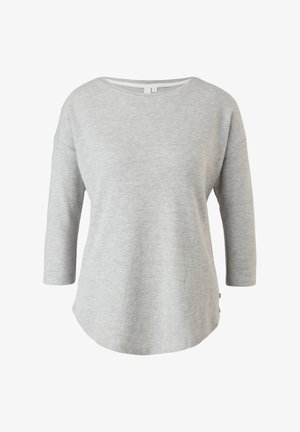 Haut gris à manches longues avec un col rond et un ourlet incurvé. Tissu doux et texturé avec une coupe décontractée ; comprend des fentes sur les côtés de l'ourlet.