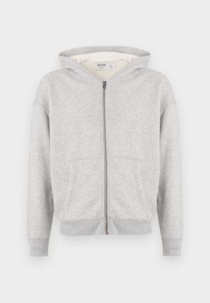 Helehall kangaga zip-up sweatjack, millel on ees taskud, pikad varrukad, soonikud mansetid ja äär ning mõõdukas suuruses kapuuts, esitatud valgel taustal.