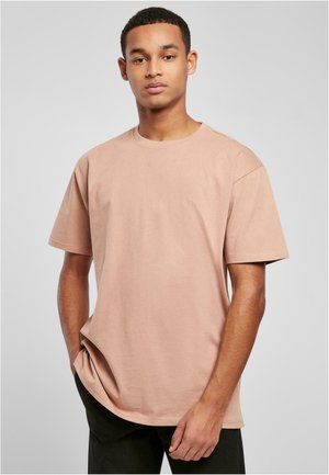 Tricou din bumbac de culoare roz deschis, cu gât pătrat și mâneci scurte. Caracteristici includ o croială lejeră și un design minimal.
