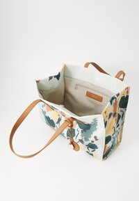Sac fourre-tout floral avec un fond bleu clair, poignées en cuir et poche intérieure. Comprend des motifs de fleurs colorés et une fermeture zippée.