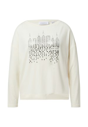 Cremfarbener Sweatshirt mit langen Ärmeln, das ein Grafikdesign von New Yorker Wolkenkratzern in Silber zeigt. Weicher Stoff mit lässiger Passform.
