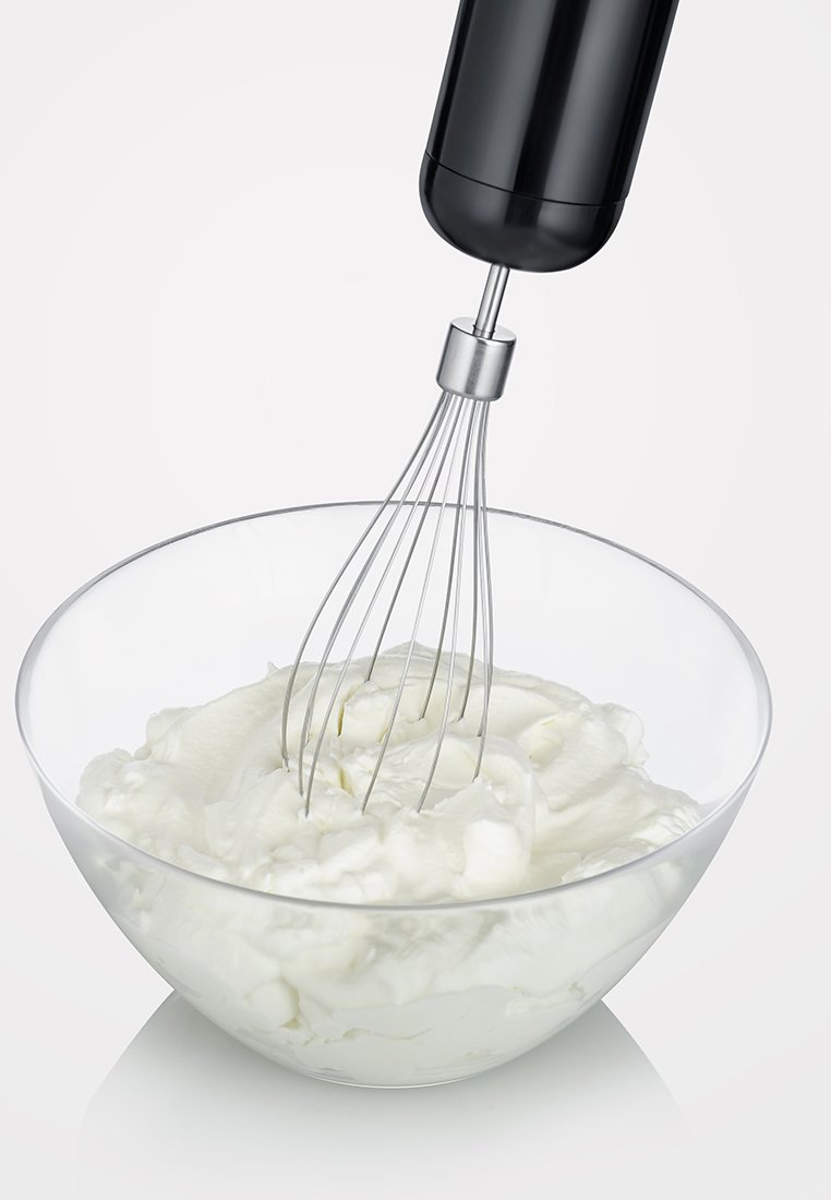 Schwarzer elektrischer Handmixer mit einem Schneebesen aus Edelstahl, schwebend über einer klaren Glasschüssel, die mit weißem Schlagsahne gefüllt ist.