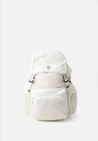 White backpack with shearling texture, front zipper pocket, flap top with silver buckle, and adjustable straps on a white background.