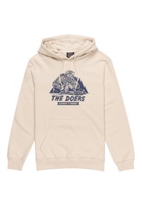 Beige hoodie made of soft fabric featuring a front pocket, drawstring hood, and dark blue graphic of a character with skateboarding elements.