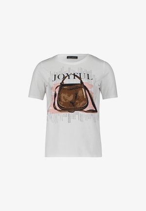 T-shirt en coton blanc avec un graphique de sac brun portant le mot "JOYFUL" au-dessus, accentué par des points noirs dispersés et un fond rose.