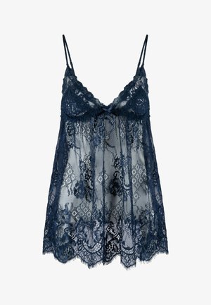 Camisole en dentelle marine avec des bretelles spaghetti réglables, présentant des motifs floraux complexes, un détail en forme de nœud à l'avant et un ourlet festonné.