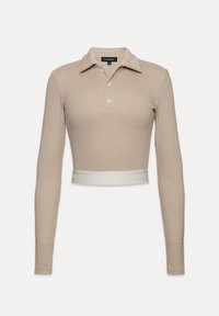 Polo-stiilis lühike topp heledast beežist ribakangast, millel on krae, kolm nuppu ja valge riba „LA MANIA“ logoga ääres.