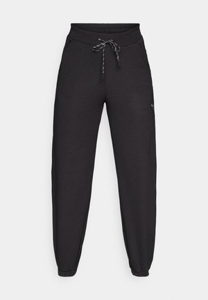 Pantaloni de jogging negri, fabricați dintr-un material moale și elastic, cu talie ajustabilă prin șnur, buzunare laterale și mansete înguste la glezne.