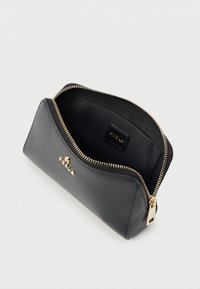 Black leather cosmetic case with a textured finish, gold zipper, and Furla logo. Open design shows a lined interior with a brand tag.